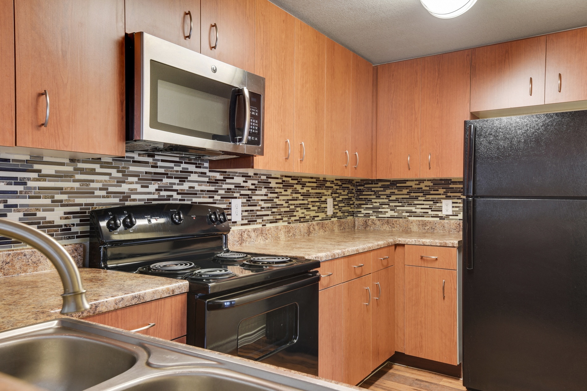 a kitchen with stainless steel appliances and granite counter tops